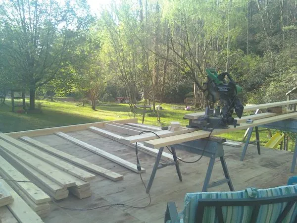 Miter saw and framing lumber on a deck under construction in Ferdinand